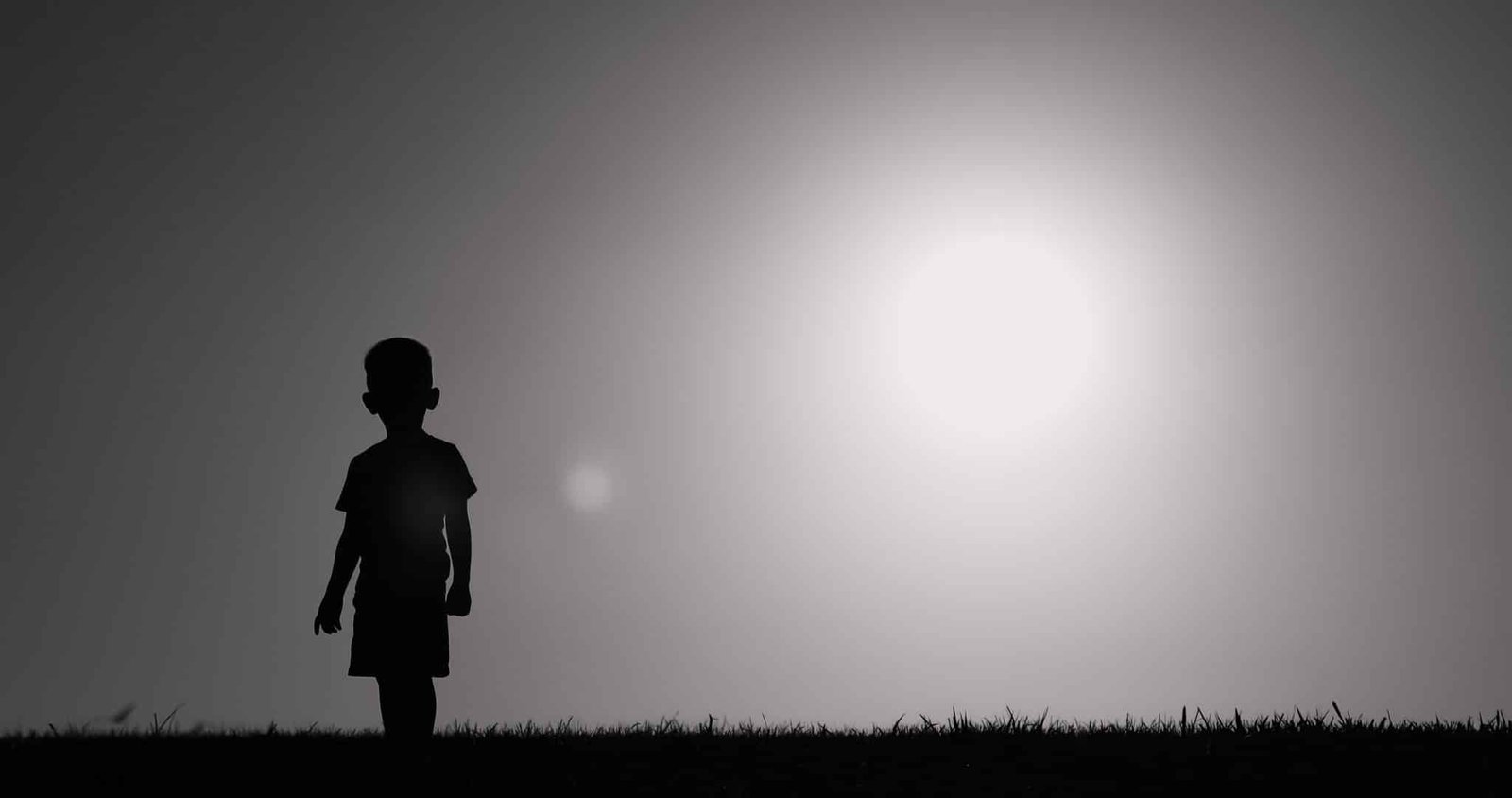 Silhouette of small child walking