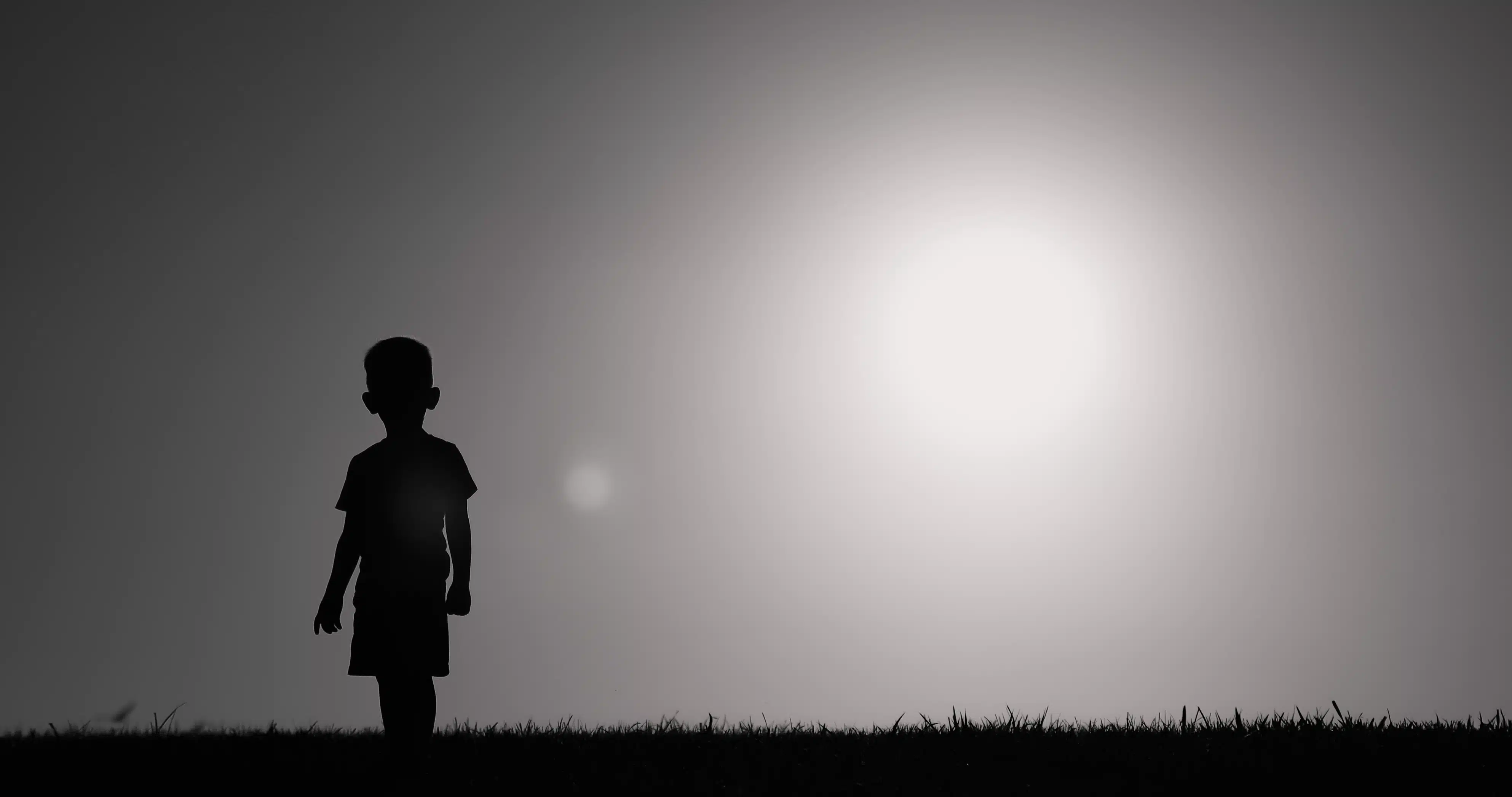 Silhouette of small child walking