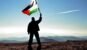 Successful silhouette man winner waving Palestine flag on top of the mountain peak