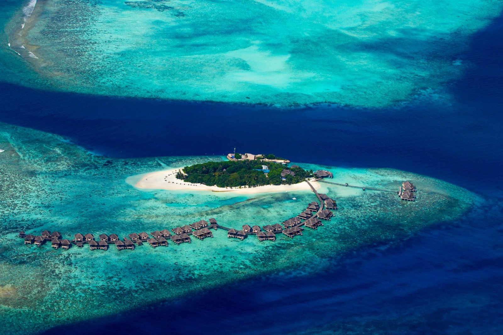 aerial view of tropical paradise maldives island resort with coral reef and turquoise blue ocean tourism background