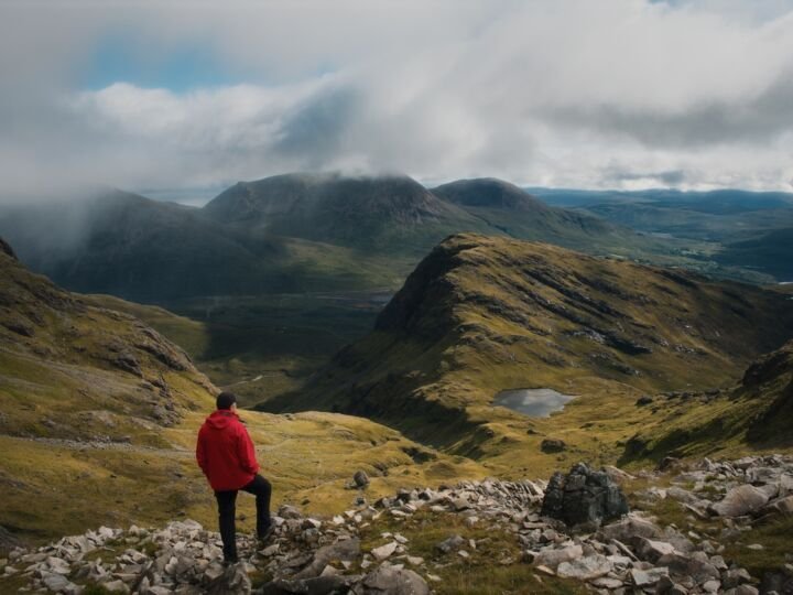man standing on mountain in scotland