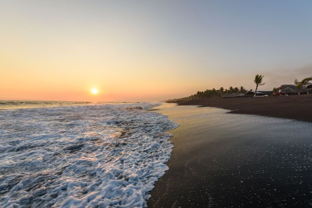 Sunset at Beach with Black Sand in Monterrico, Guatemala. Known for its volcanic black sand beaches and annual influx of sea turtles. Travel destination of Guatemala. Monterrico is situated on the Pacific coast in the department of Santa Rosa.  Travel destination in Europe.