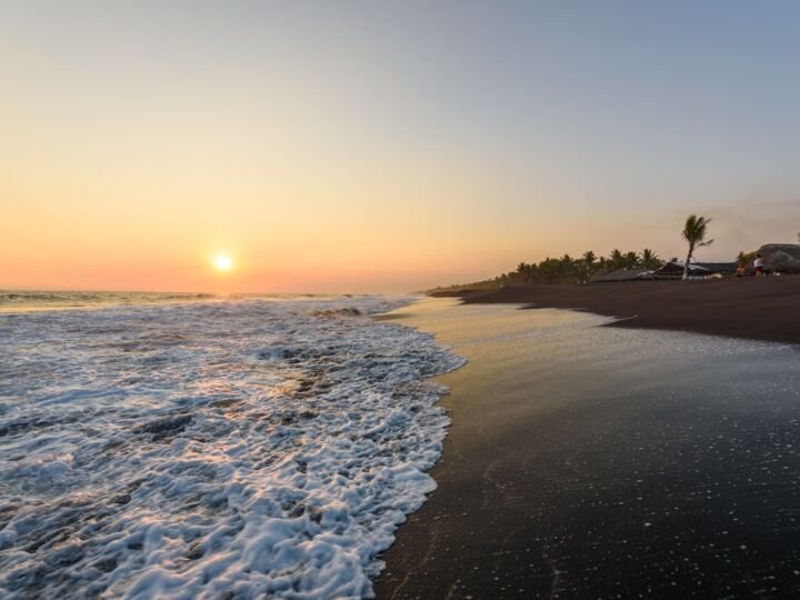 Sunset at Beach with Black Sand in Monterrico, Guatemala. Known for its volcanic black sand beaches and annual influx of sea turtles. Travel destination of Guatemala. Monterrico is situated on the Pacific coast in the department of Santa Rosa. Travel destination in Europe.