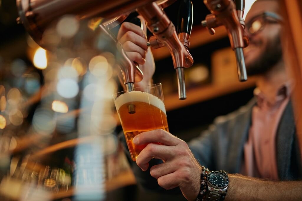 beer being poured from tap