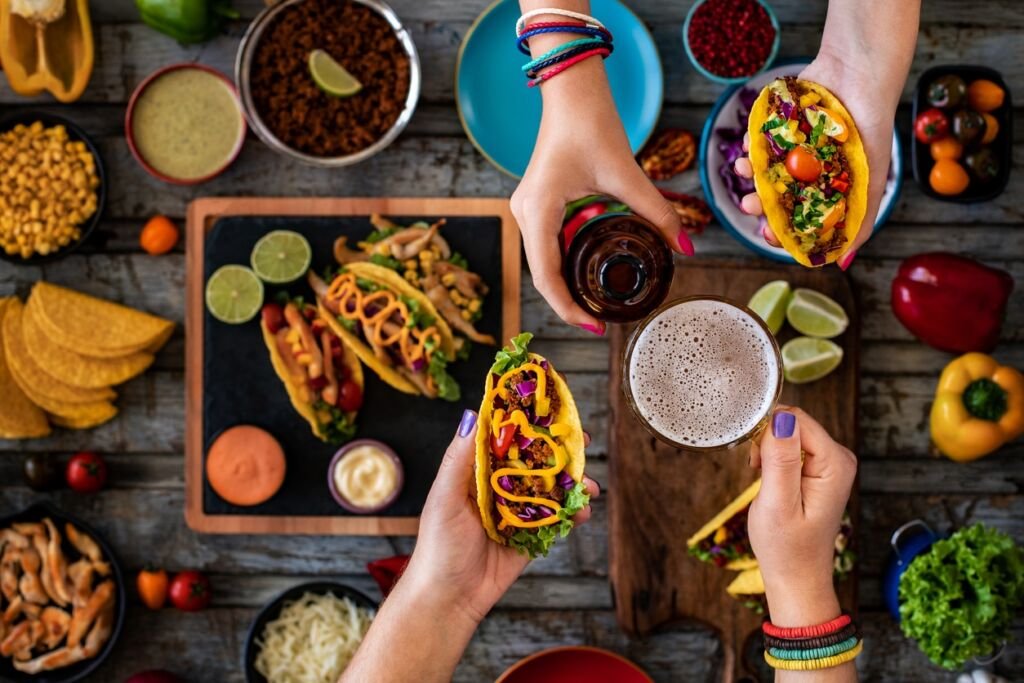 Many types of tacos on the table.