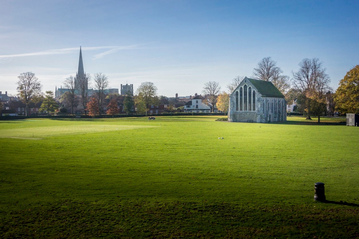 Chichester Guildhall, an ecclesiastical building in Priory Park Chichester, West Sussex, England. Rare example of a complete 13th-century Franciscan church. With Chichester cathedral spire in the distance