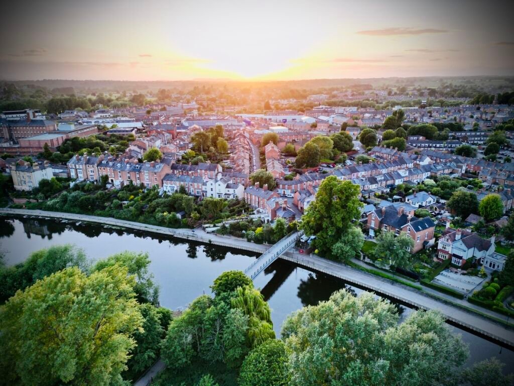 Taken near sunset, houses and fields shown from the sky by drone give a unique perspective on UK life on the suburbs of a medieval market town.