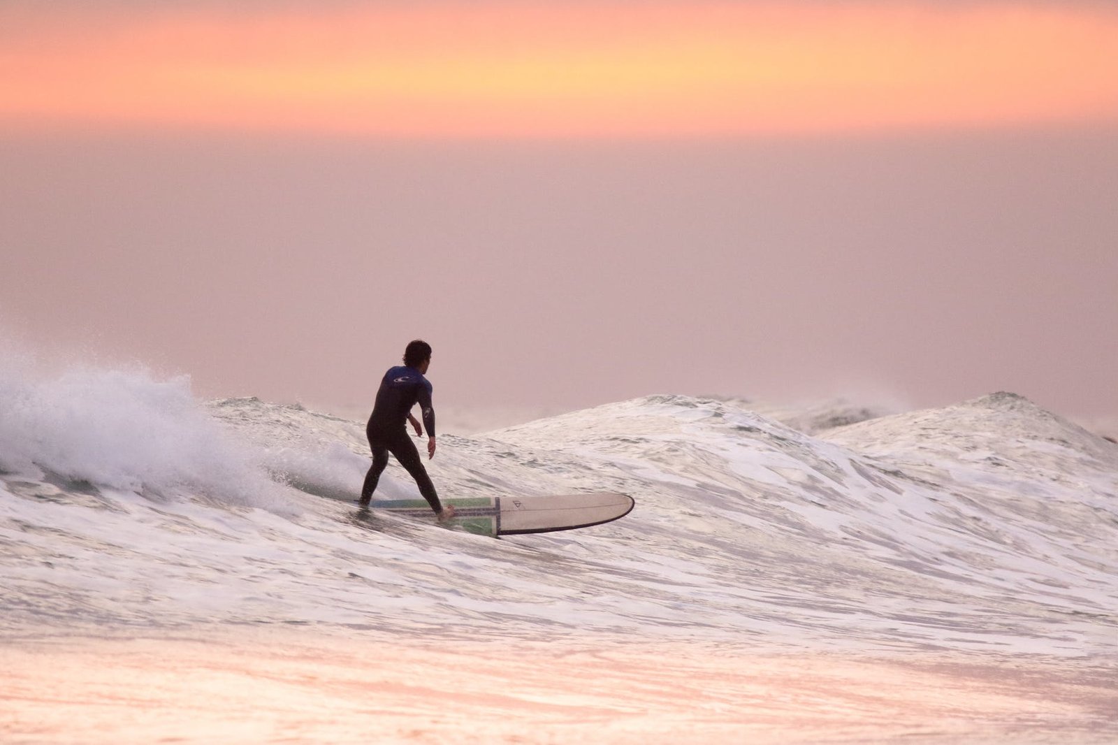 man doing surfing at golden hour
