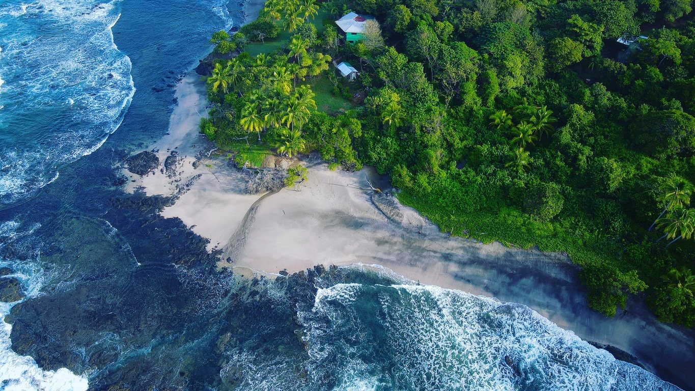 View from above of Costa Rica beach with jungle beside it