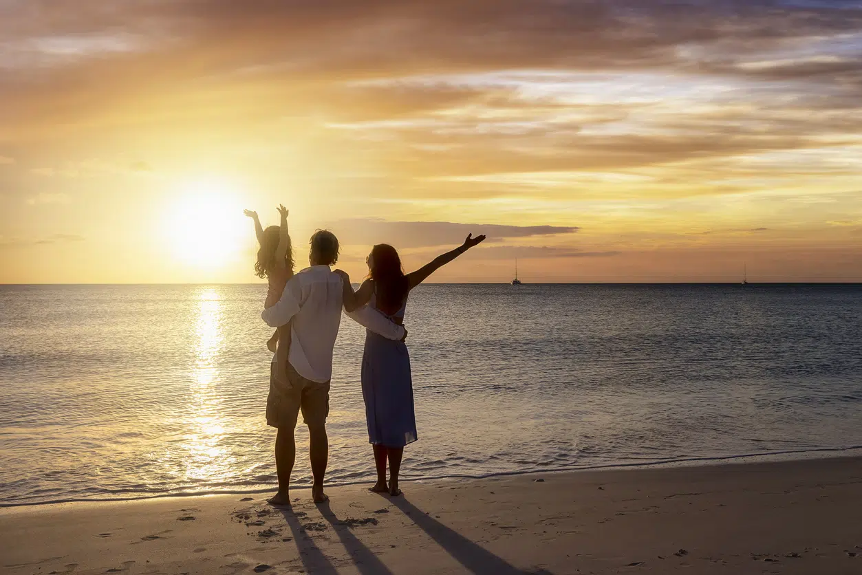 Family on beach at sunset