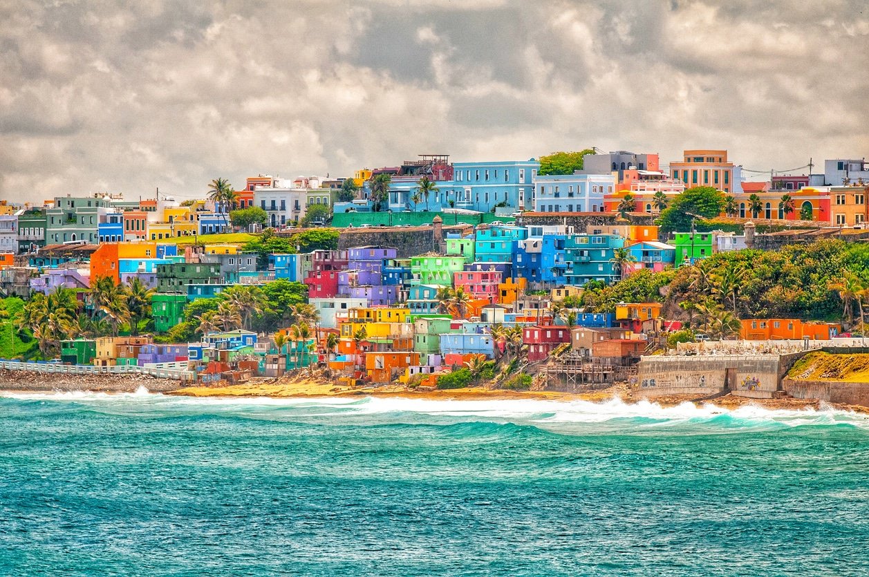 Colorful houses stacked on a hill over looking the ocean in Puerto Rico