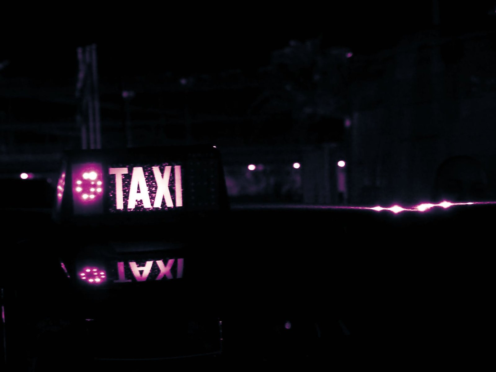 lighted taxi sign at night