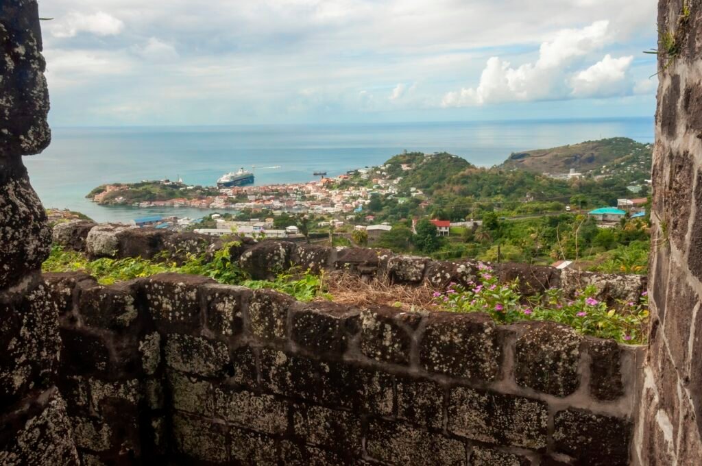 View from between the stone walls of Fort Frederick, an old Caribbean fort, to the mountains below.