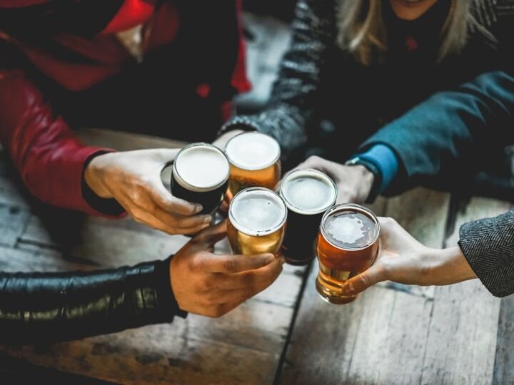friends enjoying beers at a bar