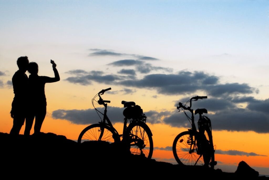 couple do selfie on the sunset with bikes landscape