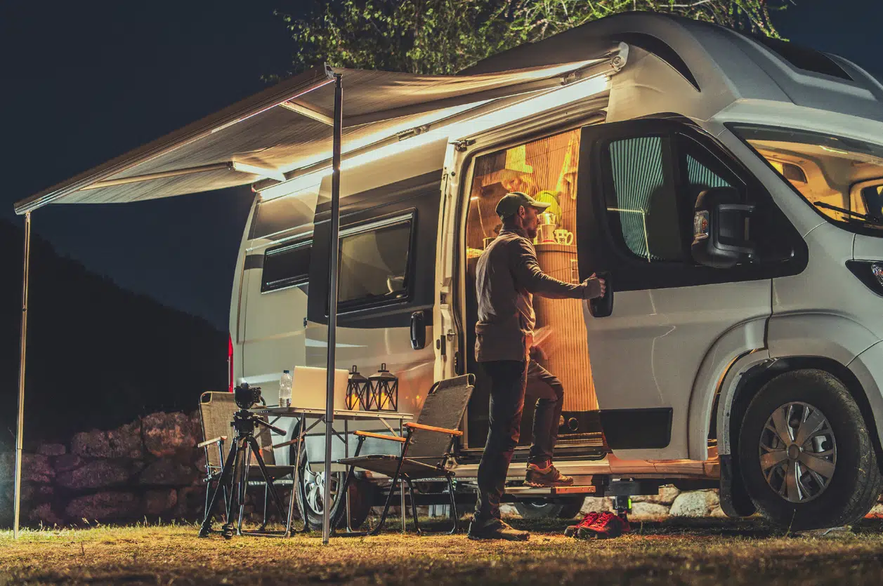 Motorhome RV Park Camping at night, person outside
