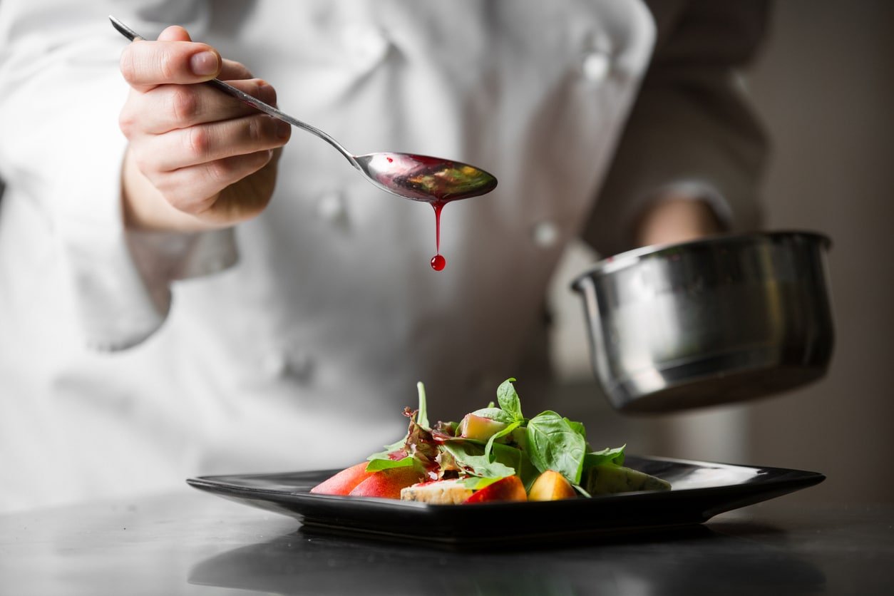 Chef adding drizzle to fine dining plate