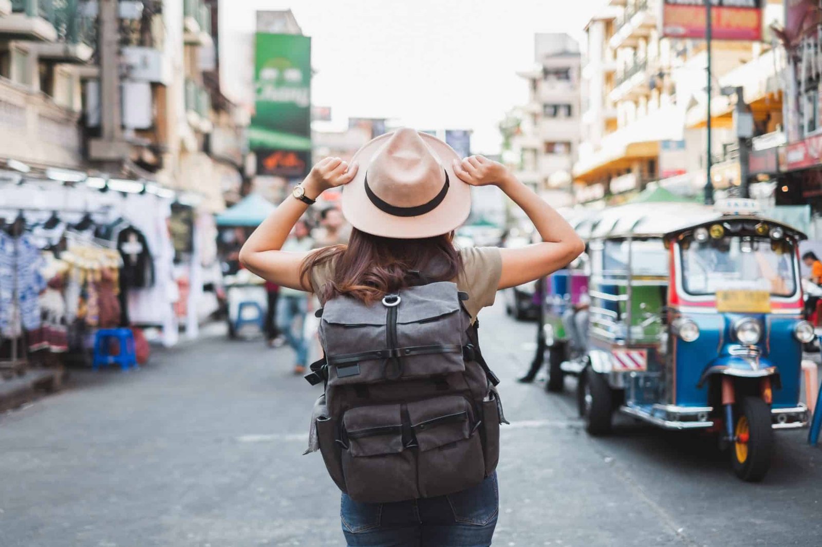 Back view of woman tourist backpacker travel in Khao San road, Bangkok, Thailand