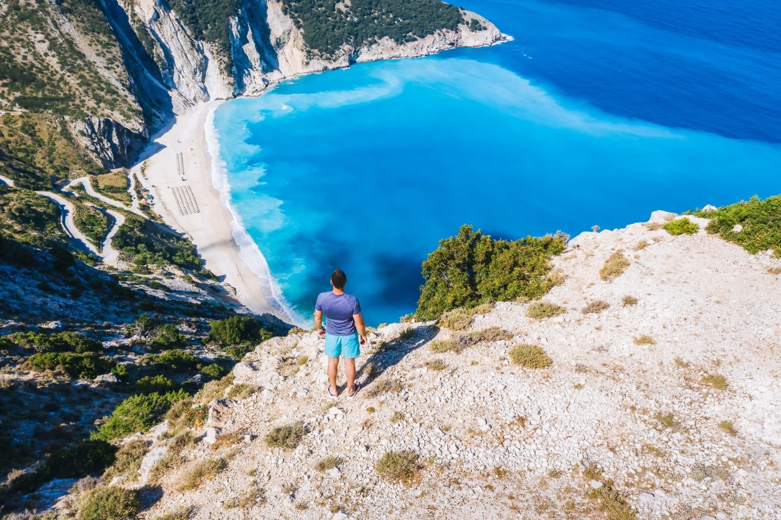 A Man standing and enjoying the view of beautiful Myrtos Beach in Kefalonia, Greece.