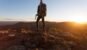 Hiker standing on cliff ledges mountain top