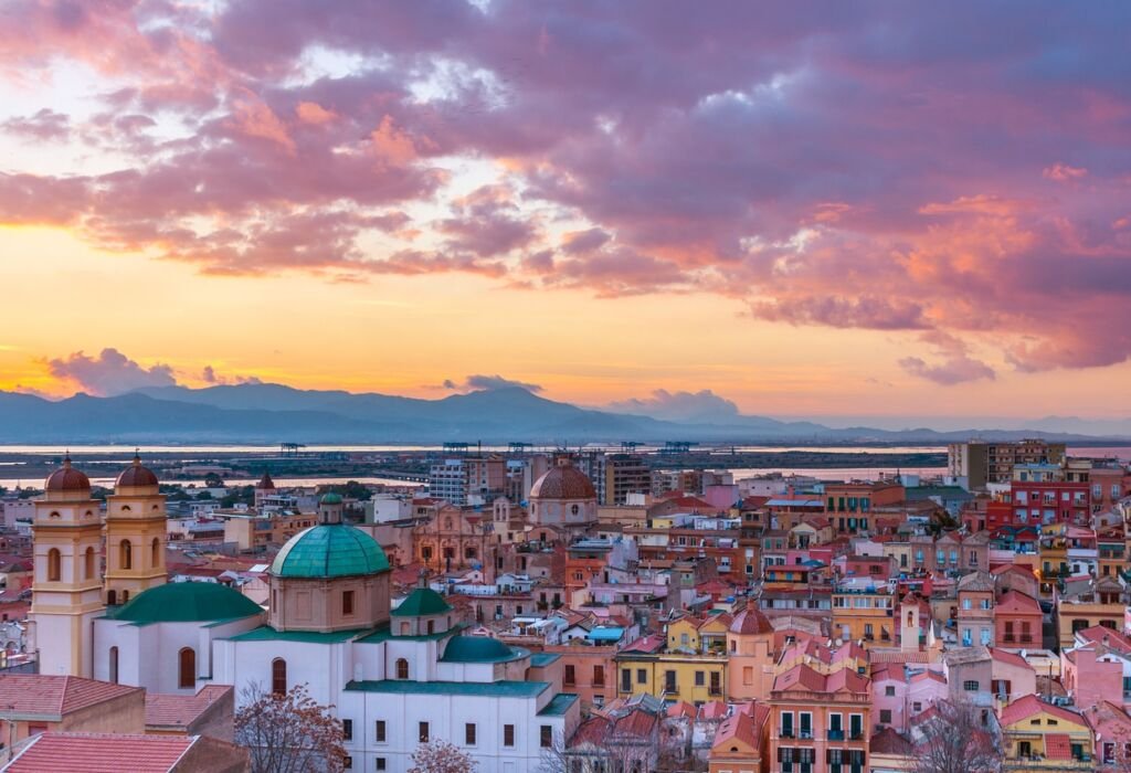 Sunset on Cagliari, evening panorama of the old city center in Sardinia Capital, view on The Old Cathedral and colored houses in traditional style, Italy.