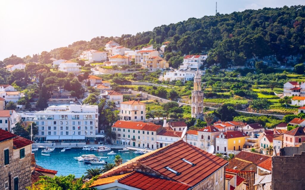Panoramic view of Hvar town with lots of red roofs in Croatia. Hvar houses and roofs mediteranean town. Beautiful stacked houses in Hvar off the Dalmatian coast in Croatia.