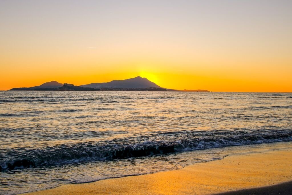 the beach of Miseno at sunset with Procida island on the background