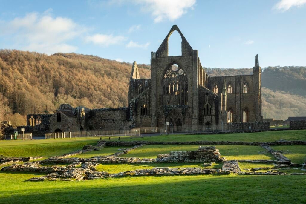 Tintern Abbey built on the Welsh side of the River Wye bordering Monmouthshire in Wales and Gloucestershire in England UK