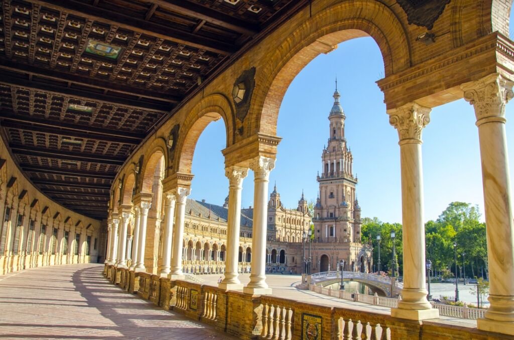 Plaza de Espana in Seville, Spain, blue skies and building framed by arch
