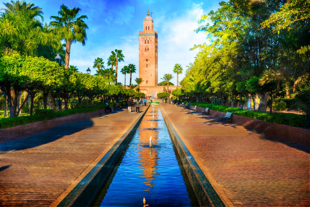 The Koutoubia Mosque's minaret in Marrakech stands tall, a terracotta-hued masterpiece adorned with intricate geometric patterns, piercing the sky, a symbol of elegance and spiritual significance.