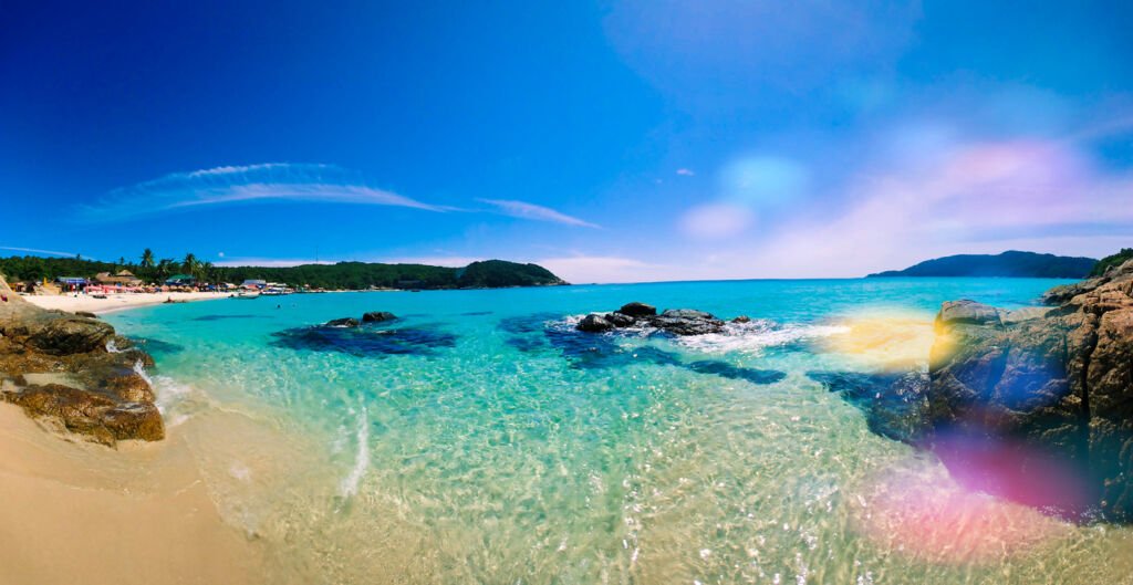 Perhentian Islands, a tropical paradise, boast sugar-white beaches and crystalline waters. Palm-fringed shores meet azure waves, where colorful marine life dances beneath the surface, a snorkeler's dream.