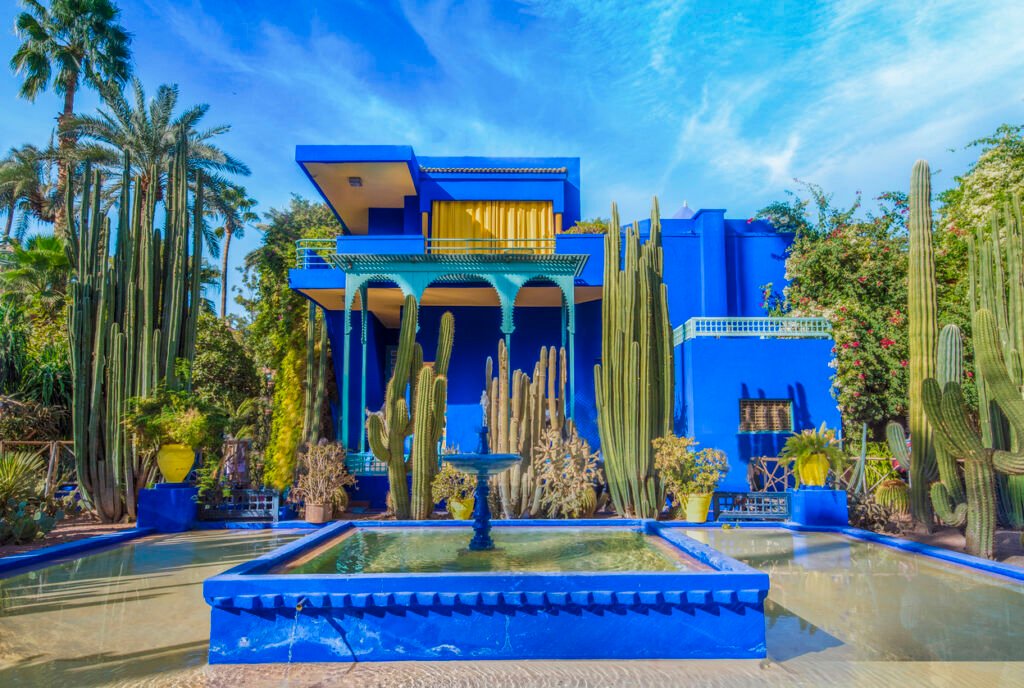 e Jardin Majorelle in Marrakech is a cozy oasis, with its lush greenery, vibrant blue accents, and exotic plants, providing a tranquil escape from the bustling city surroundings.
