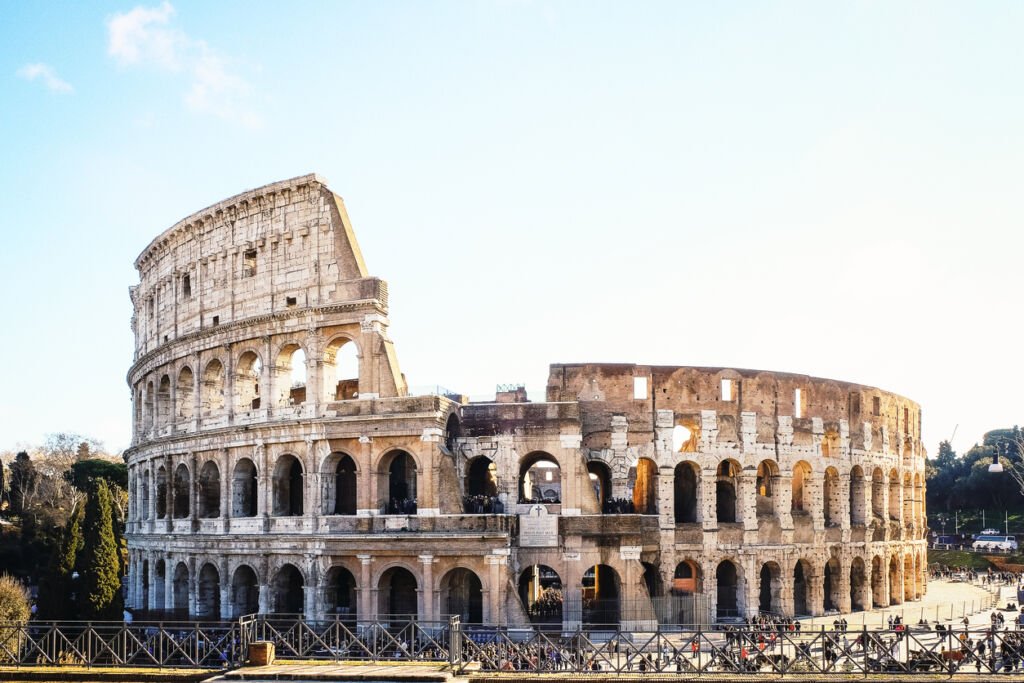 Rome's Colosseum stands colossal and resplendent, a monument to history, on a radiant spring day. Timeless magnificence etched against the azure sky, inviting awe and admiration.