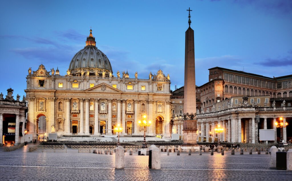 St. Peter's Square at dawn radiates serenity, bathed in the soft glow of morning light. The majestic colonnade embraces the Vatican, inviting quiet contemplation in the heart of Rome.