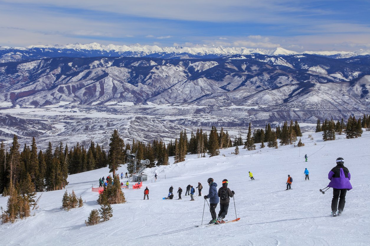 Winter magic unfolds in the Colorado Rockies, as Aspen Snowmass Mountain becomes a playground for a vibrant throng of skiers and snowboarders. A kaleidoscope of colors against a backdrop of pristine snow.