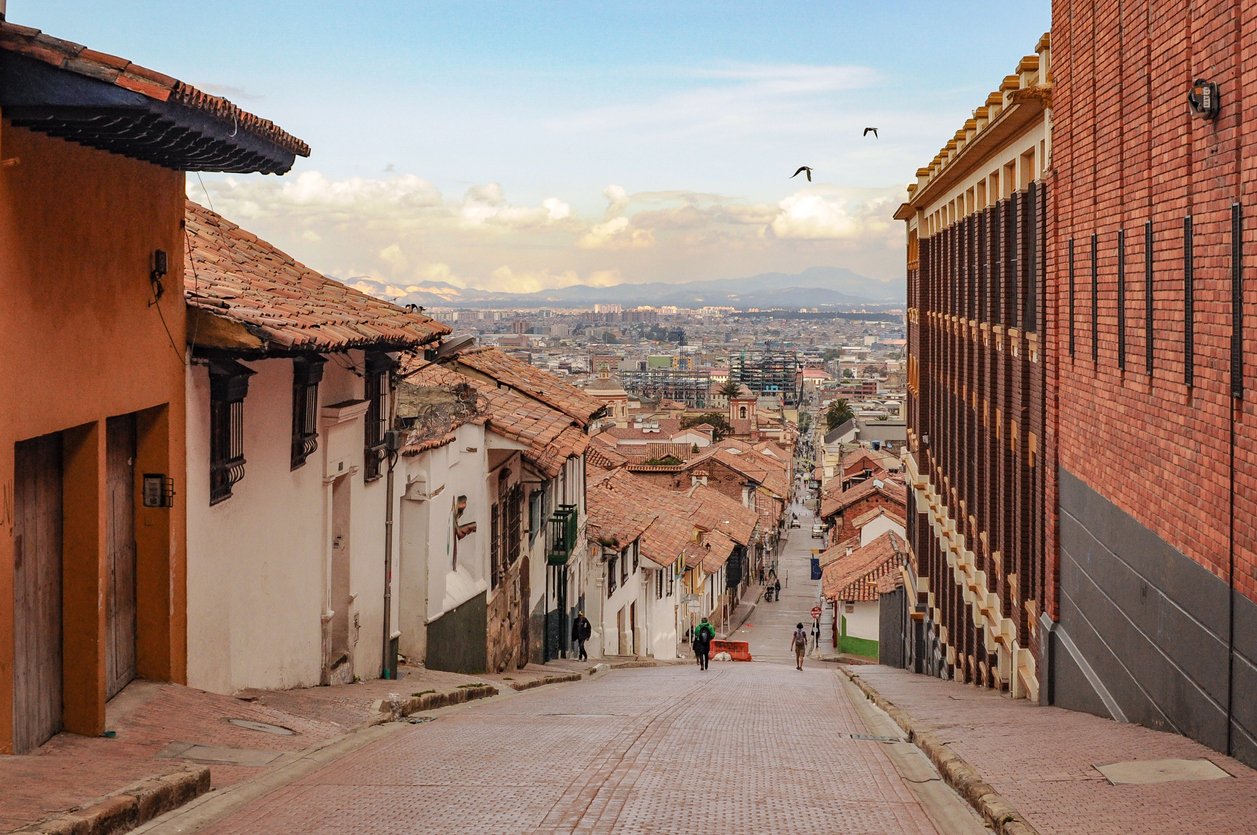 La Candelaria's old town in Bogotá unveils a steep street, cobblestones worn by history. Colonial facades stand tall, witnessing the city's ascent, creating a picturesque blend of past and present.