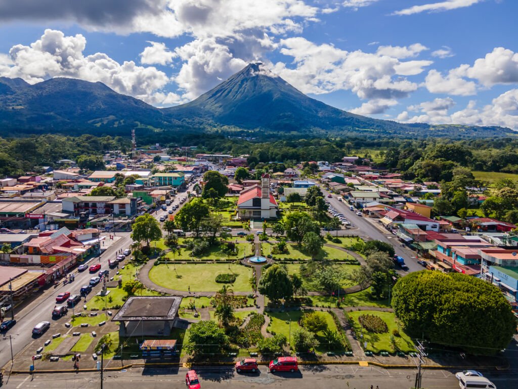 Nestled beneath the majestic Arenal Volcano, San Carlos La Fortuna Town enchants with its charm. Aerial vistas reveal the town's heart, where Arenal Volcano and La Fortuna Church stand in harmony.