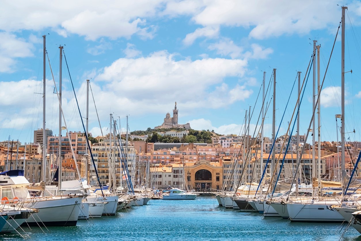 Marseille's Old Harbor, a maritime masterpiece, boasts historic charm. Quaint fishing boats intermingle with vibrant cafes along the water's edge, evoking centuries of Mediterranean allure and seafaring tradition.