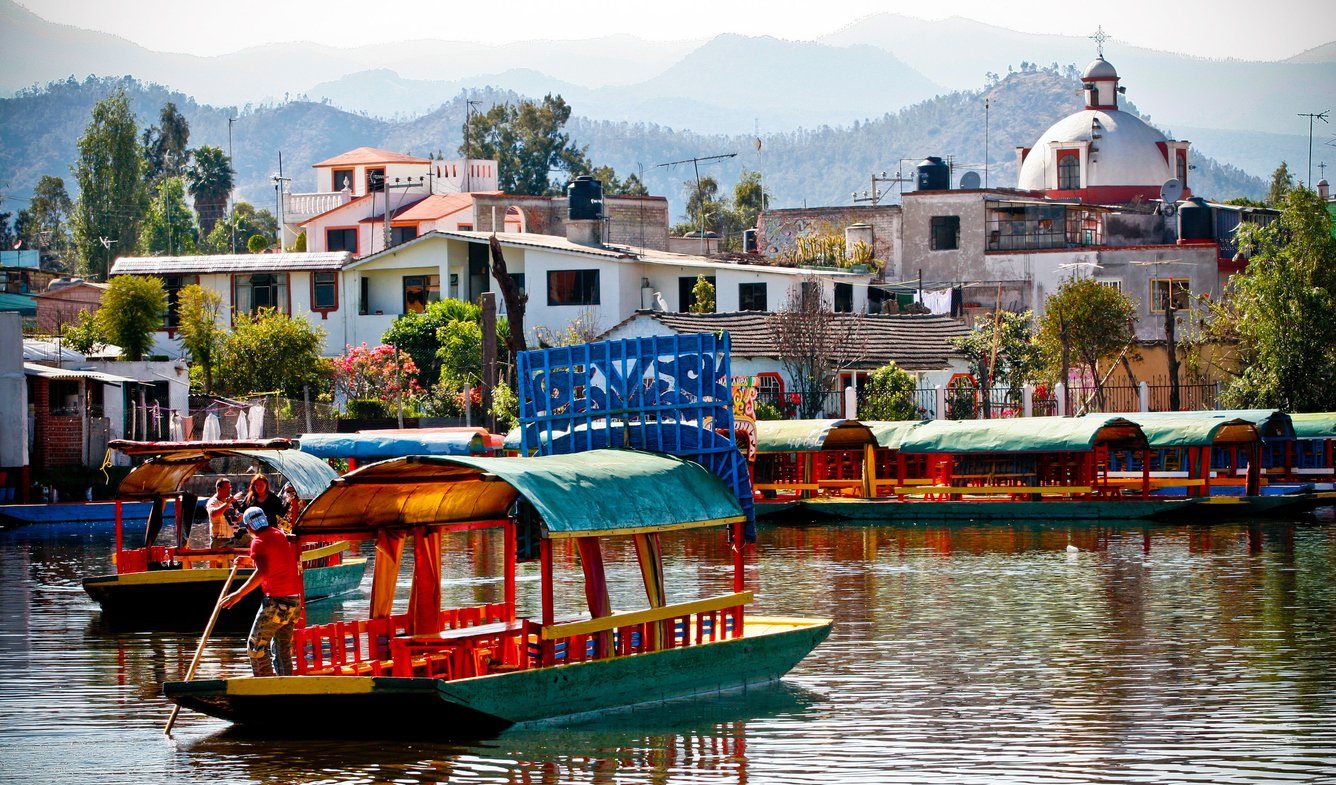 In Mexico City, Xochimilco's canals host colorful trajineras, attracting thousands annually. UNESCO declared the floating gardens a World Heritage Site in 1987, preserving a cultural and ecological treasure.