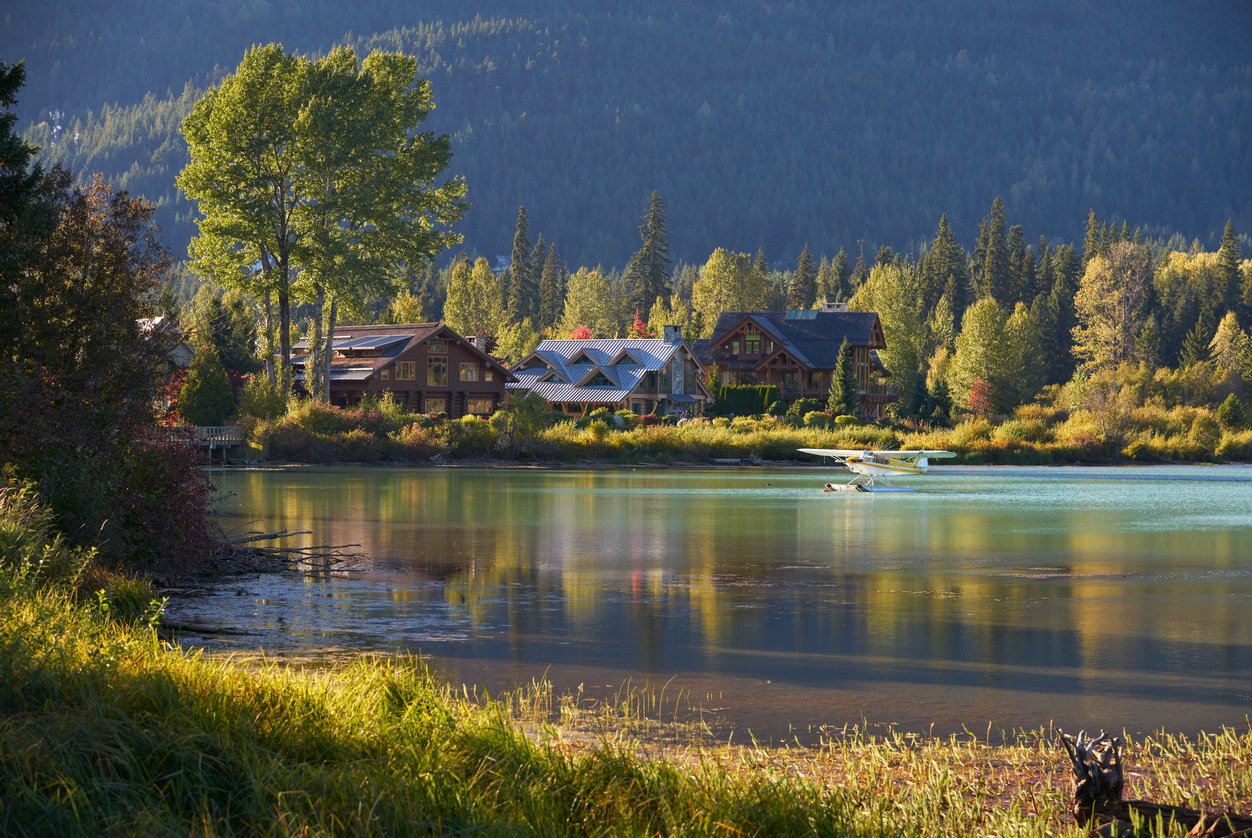 Gently skimming Green Lake's pristine surface, a float plane in Whistler, British Columbia creates ripples of tranquility. Reflecting the surrounding mountains, it embodies the serenity of this Canadian gem.