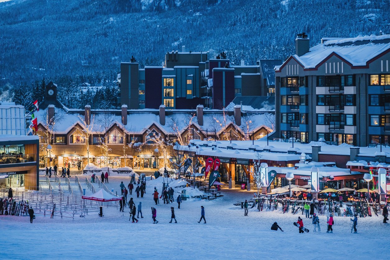 Whistler Village bustles with life as people stroll at the Whistler Blackcomb base in British Columbia, Canada. The air is filled with the festive energy of winter adventure.