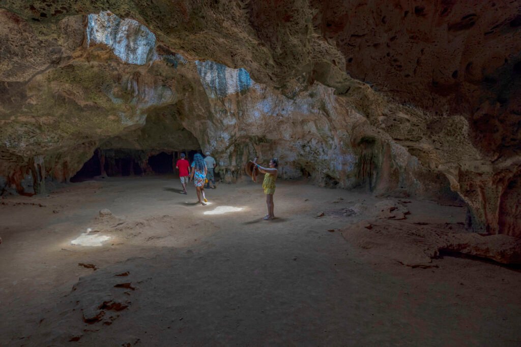 Aruba, Oranjestad, 05.08.2023: Tourists explore Quadirikiri Cave, marveling at its unique ceiling formations created by natural holes, adding an awe-inspiring dimension to the island's rich natural wonders.