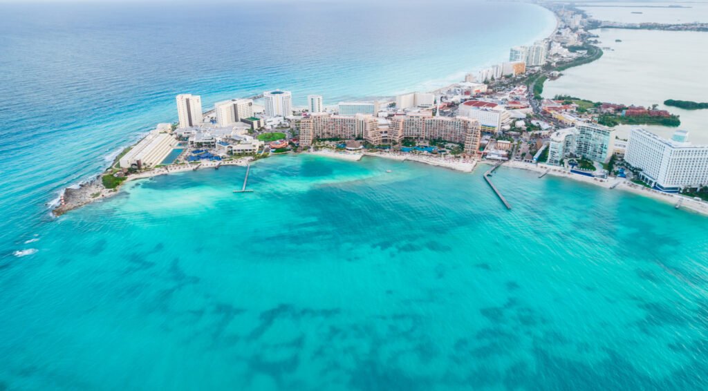 Aerial view of Cancun's hotel zone, Mexico. Caribbean beauty unfolds with Playa Caracol's beach and the iconic Kukulcan road, epitomizing the enchanting allure of Riviera Maya in Quintana Roo, Yucatan Peninsula.