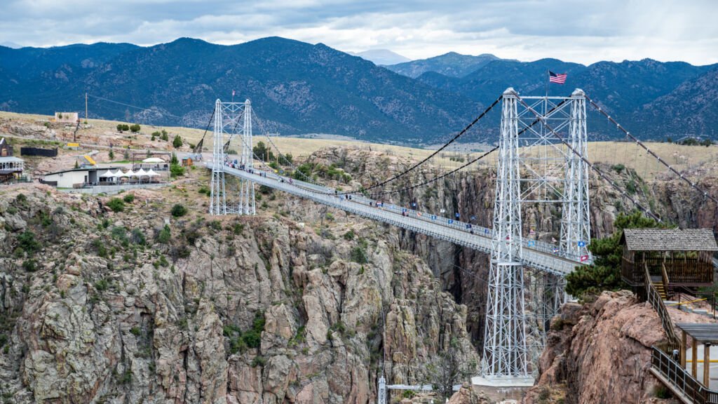The Royal Gorge Pedestrian Bridge in Colorado spans the dramatic chasm, offering breathtaking views of the rugged canyon below. A marvel of engineering, this suspended bridge promises an unforgettable experience.