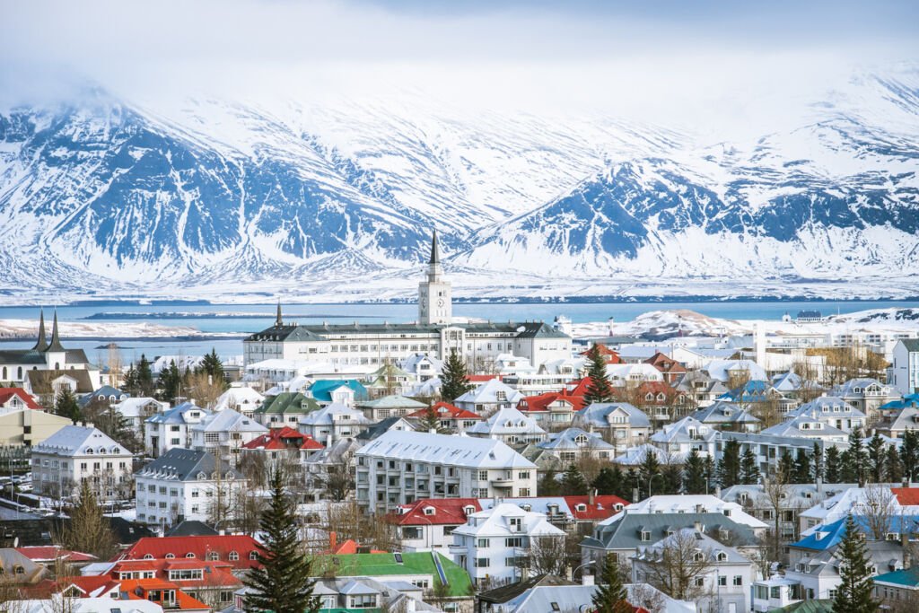 Reykjavik, Iceland's capital, transforms into a winter wonderland when viewed from above. Blanketed in snow, the cityscape sparkles with festive lights, creating a magical and serene atmosphere.