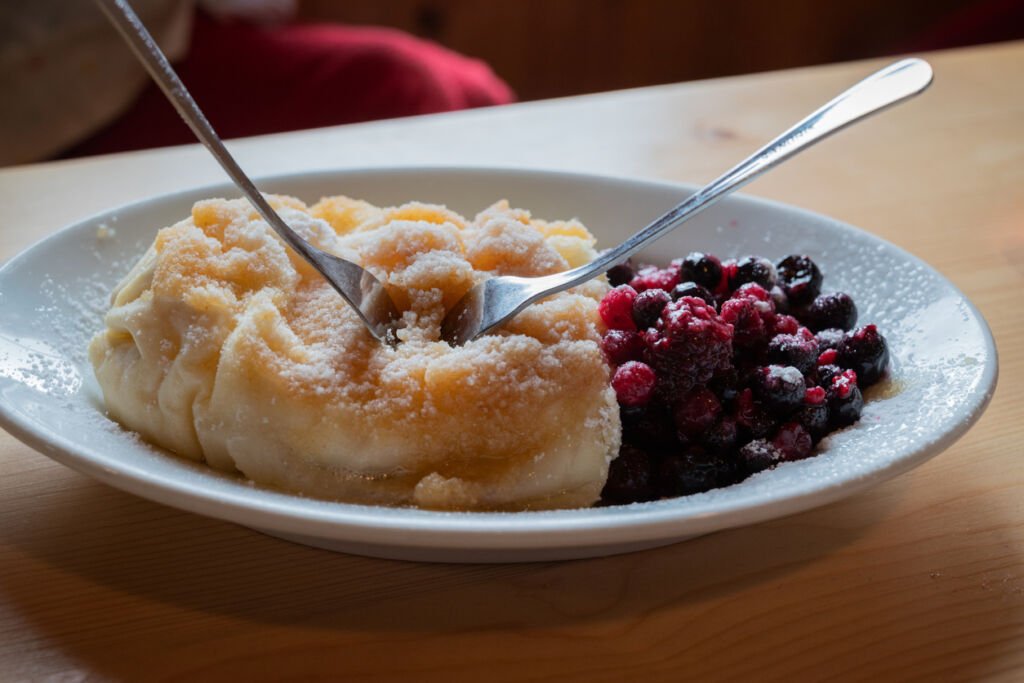 Savor the delight of truklji, a quintessential Slovenian dessert. This traditional dish combines soft dough and a sweet cottage cheese filling, artfully adorned with fresh berries for a delicious culinary experience.