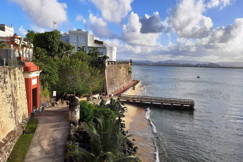 In Old San Juan, Puerto Rico, the City Gate stands sentinel, flanked by the formidable La Fortaleza building, guarding the historic district with timeless strength and colonial elegance.